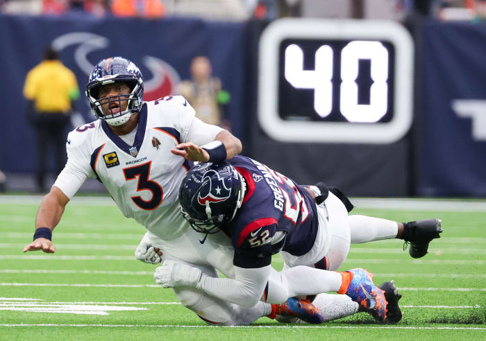 Dec 3, 2023; Houston, Texas, USA;Denver Broncos quarterback Russell Wilson (3) is hit by Houston Texans defensive end Jonathan Greenard (52) after the pass in the second quarter at NRG Stadium. Mandatory Credit: Thomas Shea-USA TODAY Sports